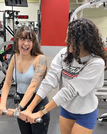 Two friends laughing together while training at Super Future Fitness