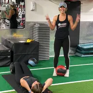 An SFF personal trainer cheering on a member on the turf