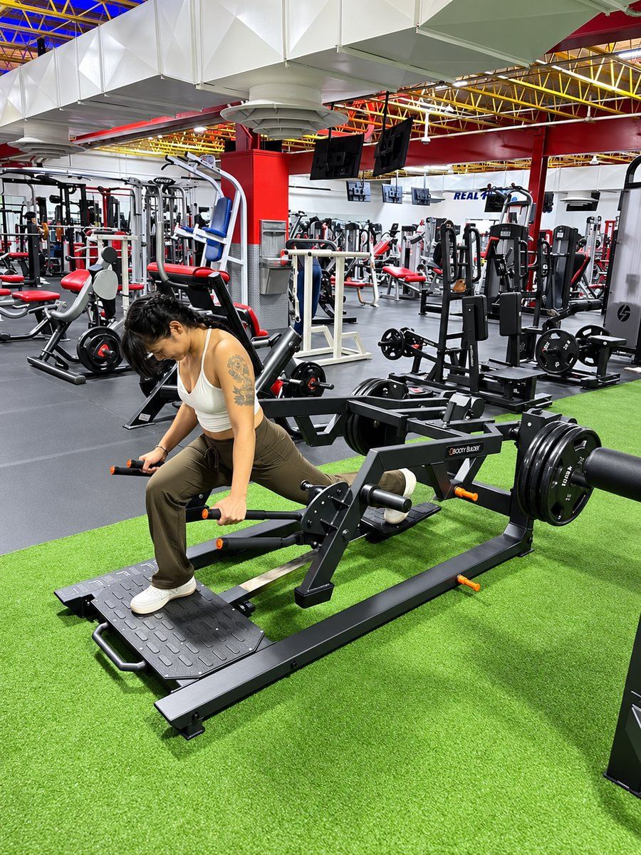 Member doing a deep reverse lunge on the Booty Builder Reverse Lunge Machine